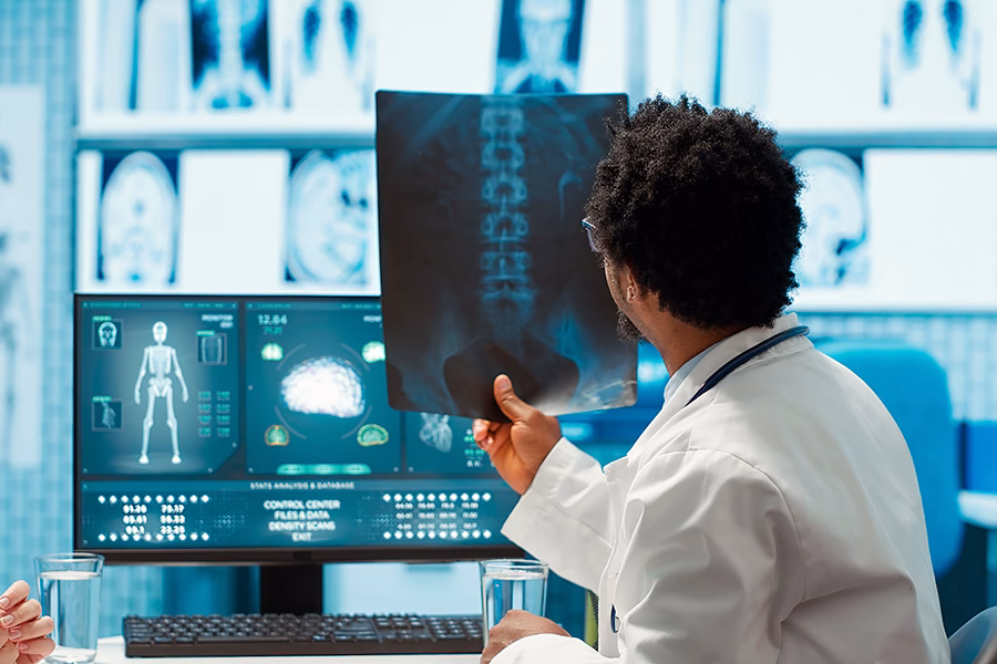 art 8 -physician-reviewing-mri-scan-x-ray-results-with-patient-medical-office (1)